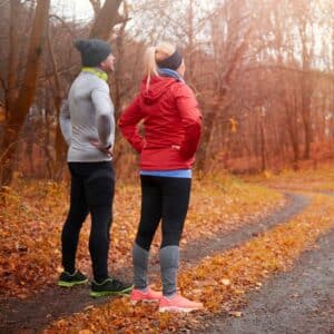 Man en vrouw bewegen in de herfst in het bos